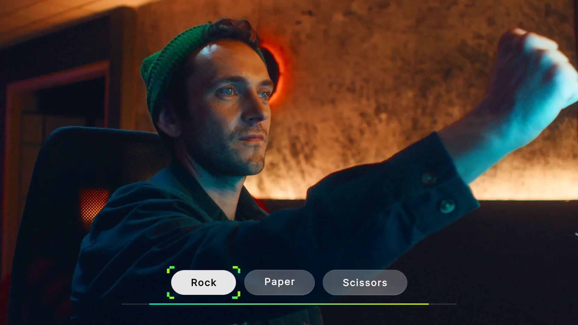 A screenshot from Hello Stranger. Cam, a man with short hair and a green toque, is playing rock, paper, scissors. Those are his three options.He's holding his hand out in a fist during the countdown.